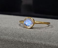 1. 14k Gold Rainbow Moonstone Gold Ring 2. Made to Order 3. Gemstone - Rainbow Moonstone 4. Jewelry Type - Gold Ring 5. Total Weight - 0.970 Gram Approx. 6. Moonstone Weight - 0.60 Carats 7. Gold Weight - 0.850 Grams Approx. 8. Moonstone Size - 6 MM 9. Gold Purity - 14k 10. Band Size - 1 MM 11. Handmade Items 12. AAA Quality Ring 13. Statement Ring 14. 1 Quantity Available 15. Ready to Dispatch in 1 - 2 days.  Pictures are taken under natural and day light. Gold Stackable Moonstone Ring, Round Shape, Sapphire Moonstone Ring Fine Jewelry Gift, Sapphire Moonstone Ring Gift, Sapphire Colored Moonstone Ring As Gift, Sapphire Moonstone Ring Perfect As A Gift, Sapphire Color Moonstone Ring As A Gift, Handmade 14k Yellow Gold Moonstone Ring, Gold Faceted Moonstone Ring, Celestial Stackable Moonstone Ring