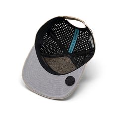 a black and grey hat with a blue patch on the front