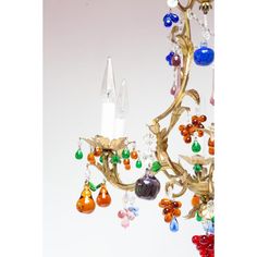 a chandelier with many different colored beads hanging from it's arms and bottom