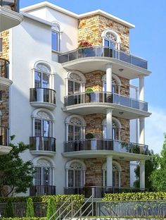 an apartment building with balconies on the second floor and balconyes above it