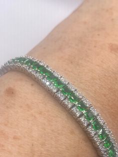 Vintage Cubic Zirconia Green Chrome Diopside 925 Sterling Silver Tennis Bracelet 7 inch The sterling silver is plated with gold rhodium to protect the bracelet from tarnish and give the appearance of white gold. This is 7 inches, for a smaller wrist my jeweler can shorten it for a $20 fee. All jewelry is shipped in a nice gift box.   Check out our over a THOUSAND great reviews Engraving is $4 per letter and is not always perfect depending on the piece. It can take a few days if the jeweler is bu Green Gemstone Bracelets In Cubic Zirconia, Green Cubic Zirconia Gemstone Bracelets, Silver Emerald-cut Tennis Bracelet As Gift, Green Cubic Zirconia Diamond Bracelet For Formal Occasions, Silver Emerald Cut Tennis Bracelet As Gift, Elegant Green Sterling Silver Jubilee Bracelet, Green Cubic Zirconia Bracelet For Gift, Luxury Green Cubic Zirconia Bracelets, Formal Green Cubic Zirconia Diamond Bracelet