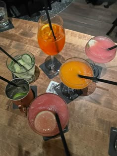 several different types of drinks on a wooden table