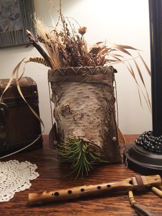 a wooden container filled with plants on top of a table next to a musical instrument