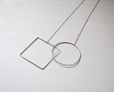 Sale details Free shipping on orders of $50 or more! Geometric handmade pendant with two figures, in sterling silver thread of 1 x 1 mm thick a square and a circle. Both pieces are linked to make a movement when you use it. The  The chain is loger, if you want something different, please let me know! Modern Sterling Silver Necklace With Square Pendant, Modern Sterling Silver Square Pendant Necklace, Modern Handmade Necklace With Square Pendant, Modern Handmade Square Pendant Necklace, Minimalist Silver Square Necklace, Minimalist Square Silver Necklace, Minimalist Geometric Sterling Silver Necklace, Minimal Contemporary, Open Bangle Bracelet