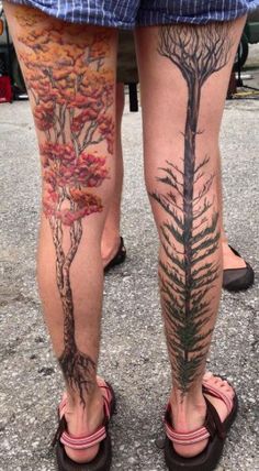 two people with tattoos on their legs standing next to each other