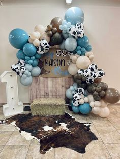 a birthday decoration with balloons and cow print