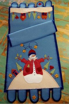 an oven mitt with a snowman on it