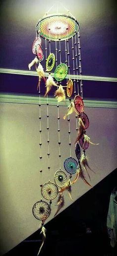 a wind chime hanging from the side of a wall