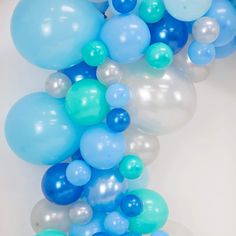 blue and white balloons floating in the air