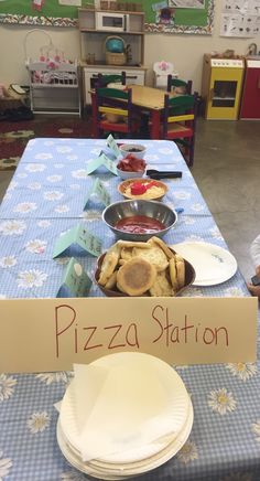 a table topped with plates and pans covered in pizza sitting on top of a blue checkered table cloth