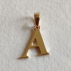 This is an exquisite initial charm pendant set in 14K Solid Gold.  An elegant design, perfect for any occassion. ITEM DETAILS: ✓ Letter : A ✓ Gold Kt: Solid 14K Yellow Gold ✓ 14 K Gold Weight : 1.10 grams ✓ Gross Weight: 1.10 grams >>The Gold purity is guaranteed and it comes with authentic 14K gold hallmark. >>A-Z letters available on my Etsy Shop. CUSTOMER SUPPORT: We are available 24/7 to respond to all your queries! PACKAGING: The pendant comes in layers of safe and secure wrapping along with a free Handmade Jewelry Box. Initial Pendent Gold, Classic Yellow Gold Initial Necklace For Anniversary, Classic Pendant Initial Necklace, Classic Formal Initial Necklace, Classic Initial Necklace For Anniversary With Polished Finish, Classic Initial Necklace For Anniversary, Gold Initial Necklace For Anniversary With Polished Finish, Yellow Gold Initial Necklace With Charms For Anniversary, Gold Initial Necklace With Polished Finish For Anniversary