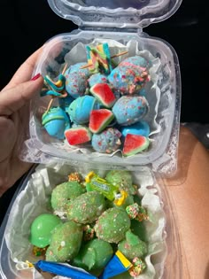 two plastic containers filled with different types of candies and fruit in it's lids