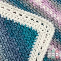 the crocheted blanket is blue, pink and white