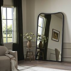 a living room with a large mirror on the wall