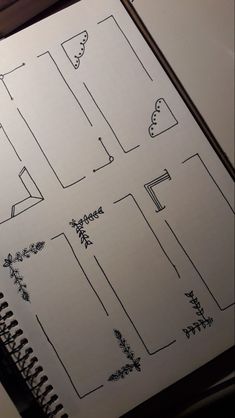 an open notebook with some drawings on it