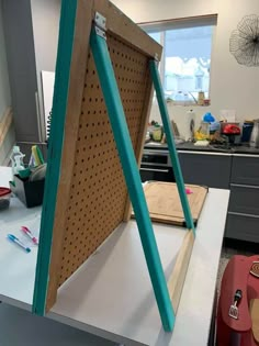 a large wooden board sitting on top of a counter in a room with lots of tools