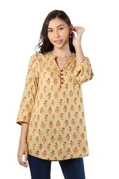 Printed onto the beige body of this rayon tunic lovely flowers are resplendent. Indian artisan Isha Jain designs this feminine tunic featuring three-quarter-length sleeves and a button-up henley neckline. Festive Floral Print Tunic, Spring Floral Print Straight Kurta Blouse, Floral Print Straight Kurta Blouse For Spring, Yellow Printed Long-sleeve Kurta, Yellow Printed Long Sleeve Kurta, Spring Yellow Tops With Printed Motifs, Spring Floral Print Kurta With 3/4 Sleeves, Spring Straight Kurta Blouse With Printed Motifs, Floral Print 3/4 Sleeve Kurta For Spring