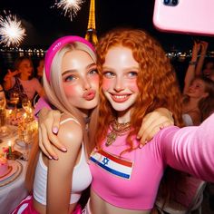 two barbie dolls pose for a photo in front of the eiffel tower