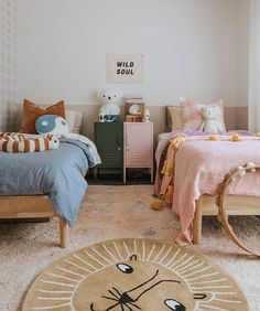 a bedroom with two twin beds and a rug on the floor in front of them