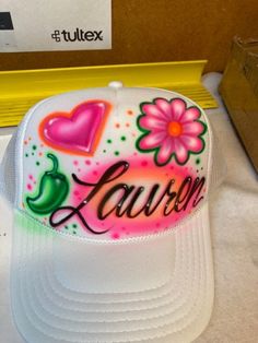 a trucker hat with the word lauren painted on it