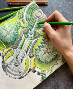 a person is drawing on paper with colored pencils