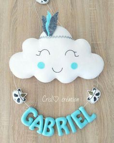 there is a cake shaped like a cloud with the word gabril on it