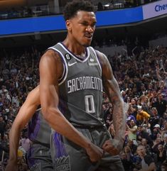 a basketball player standing in front of a crowd