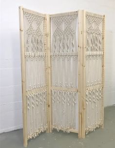 a room divider made out of bamboo with beads hanging from the top and bottom