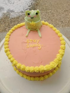 there is a cake that says stay swag on the top with a frog sitting on it