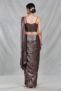 Copper brown shimmery pre-draped saree with iridescent stripes and tassel embellishments detailing. Paired with a strap sleeves sweetheart neck blouse with bloom embroidery using tonal cutdana, beads, sequin highlights. - Aza Fashions Fitted Blouse Piece For Celebration With Traditional Drape, Draped Fitted Choli For Party, Festive Fitted Pre-draped Blouse Piece, Fitted Pre-draped Saree For Celebration In Traditional Drape, Fitted Pre-draped Saree For Celebration, Festive Draped Fitted Blouse Piece, Fitted Pre-draped Saree With Sequins, Elegant Pre-draped Saree For Celebration, Bollywood Style Semi-stitched Embellished Pre-draped Saree