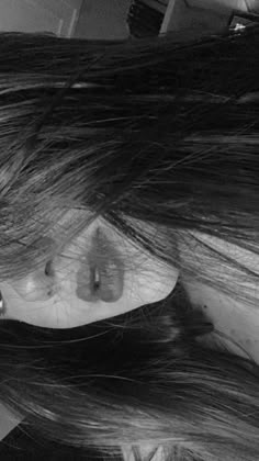 black and white photograph of a woman's head with her hair blowing in the wind