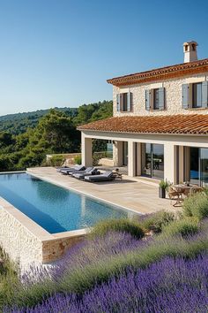 an outdoor swimming pool surrounded by lavender flowers