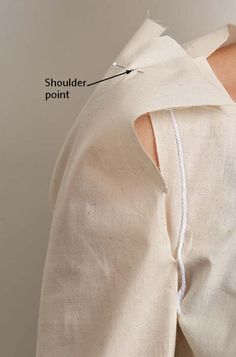 the back of a woman's shirt with an attached shoulder piece and two stitches on it