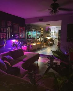 a living room filled with furniture and purple lighting