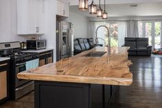 a kitchen with an island counter top in the middle