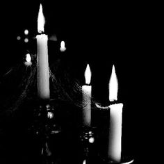 black and white photograph of lit candles