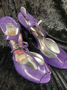 These are patent purple t-bar shoes, with high heels and straps these are size 3 heels measure: 3-inch heels these have never been worn.  come on a box Retro Ankle Strap Sandals For Party, Fitted Purple Sandals With Round Toe, Retro Open Toe Heels For Party, Fitted Purple Sandals With Ankle Strap, Retro Pointed Toe Sandals For Party, Retro Pointed Toe Party Sandals, Purple Heels With Heel Strap And Round Toe, Retro Party Sandals With 4-inch Heel, Party Mary Jane T-strap Heels