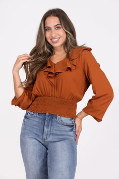 The Love Collides Top from Andree By Unit is a beautiful blouse. It features long sleeves, V neckline with ruffled detailing and smocked waistline. We love this cropped top with surplice bodice on the top. Fabric: 100% Polyester Measurements: Bust (Size M): 20'' Length (Size M): 21'' True To Size S 0-6 M 6-10 L 10-14 Fall V-neck Ruched Smocked Top, Chic Smocked Top With Elastic Long Sleeves, Fall V-neck Smocked Top With Blouson Sleeves, Long Sleeve Smocked Top With Ruffles For Fall, Long Sleeve Ruffled Smocked Top For Fall, Chic Cropped Smocked Top For Fall, Chic Long Sleeve Smocked Top With Ruched Detail, Fall V-neck Blouse With Smocked Bodice, Chic Long Sleeve Ruched Smocked Top