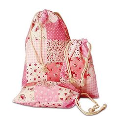 two pink bags sitting next to each other on a white surface with polka dots and flowers