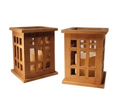 two wooden lanterns sitting next to each other