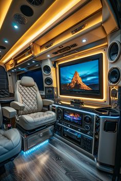 the inside of a vehicle with speakers and a television on it's wall,