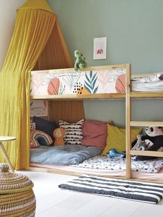 a child's bedroom with bunk beds and curtains