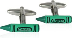 two green crayon cufflinks with black writing on them and one has a white background