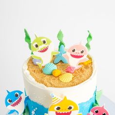 there is a cake decorated with sea animals on the top and under it, along with other decorations