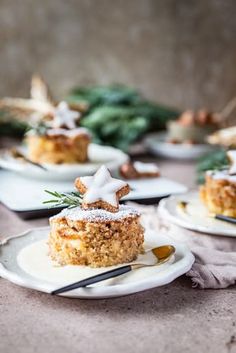 three white plates topped with desserts on top of a table