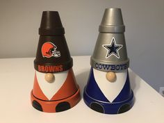 two nfl themed salt and pepper shakers sitting on a white counter top next to each other