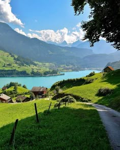 a scenic view of a green valley and lake