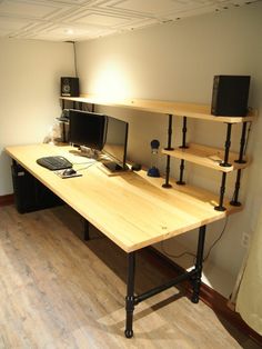 a computer desk with two monitors on it