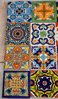 many colorful tiles are arranged on the floor