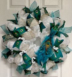 a peacock wreath is hanging on the front door